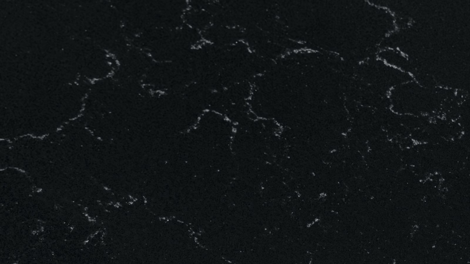 Close detail of the veining in Carrara Shadow polished quartz